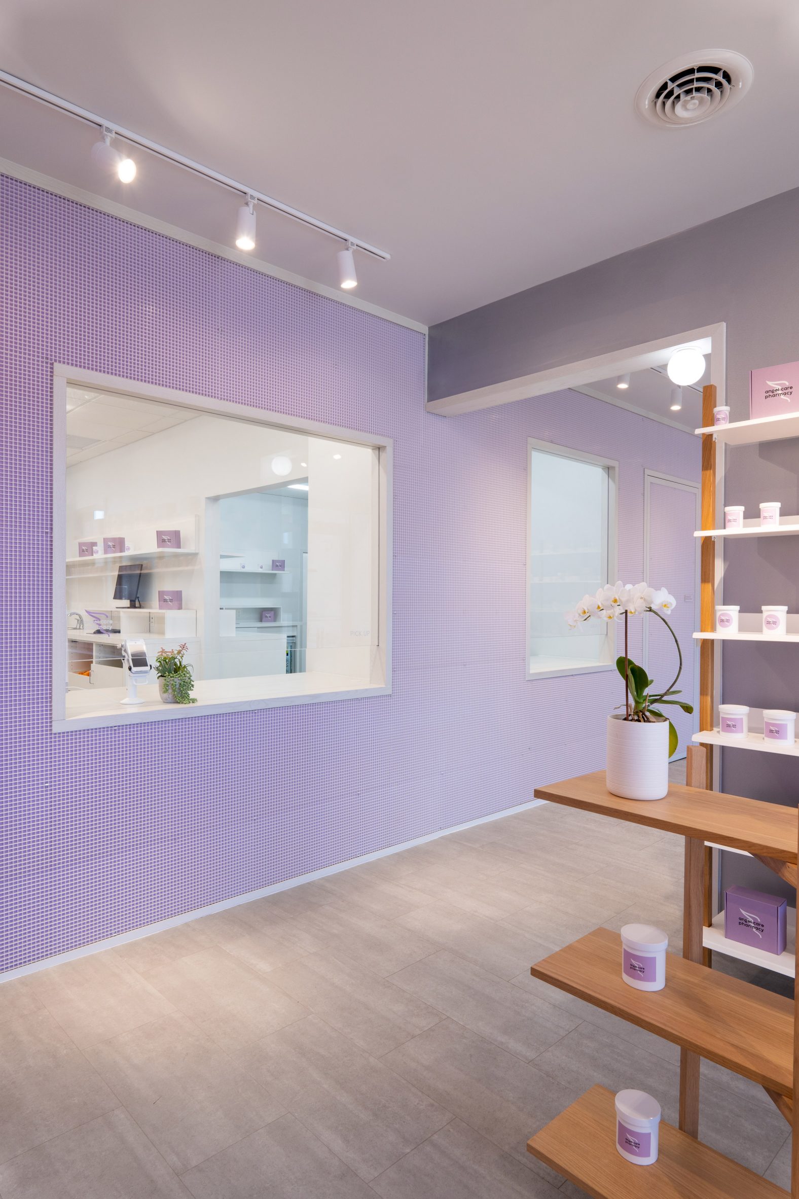 Pharmacy windows surrounded by pale purple walls with a grid overlaid