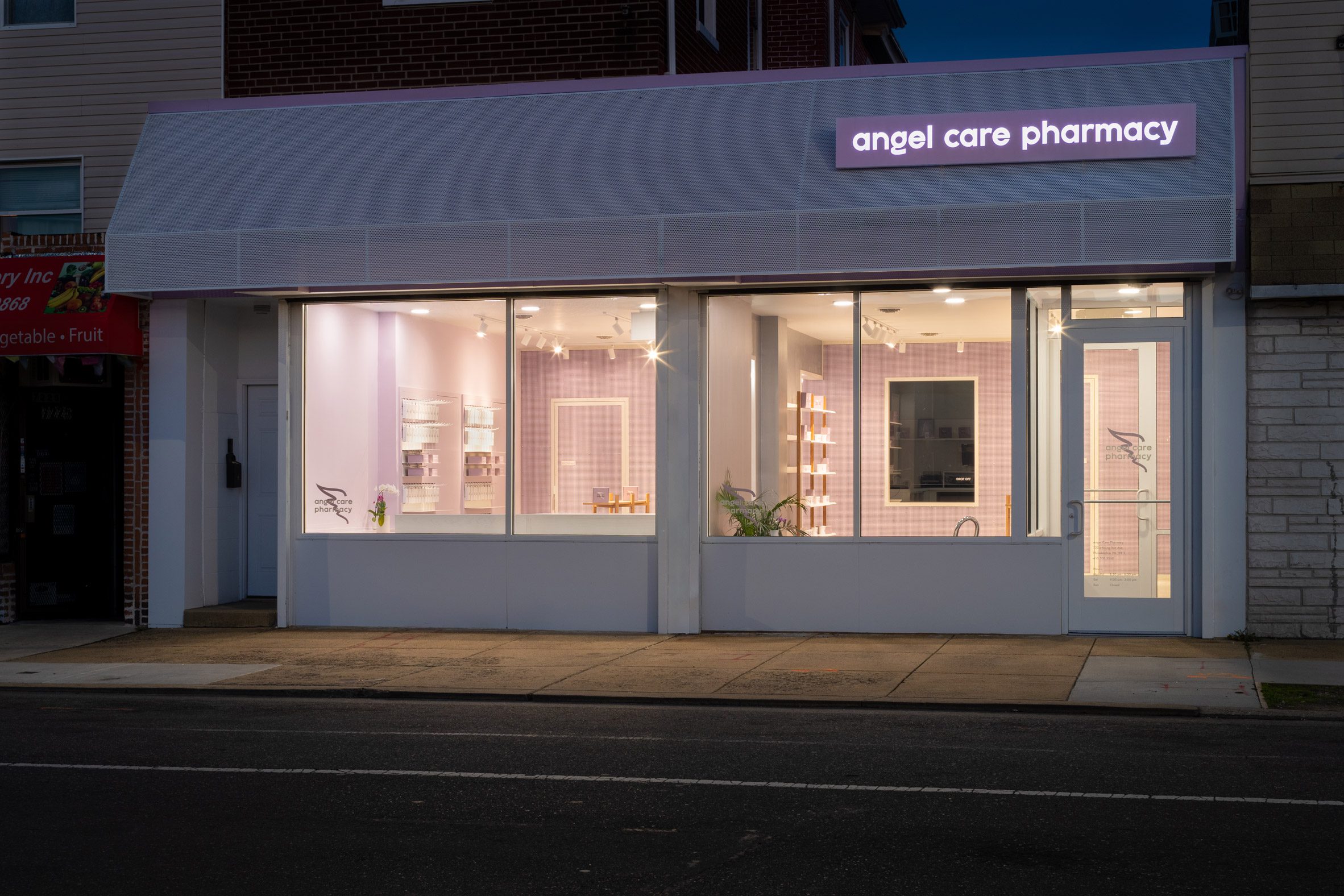 Exterior of Angel Care Pharmacy at night