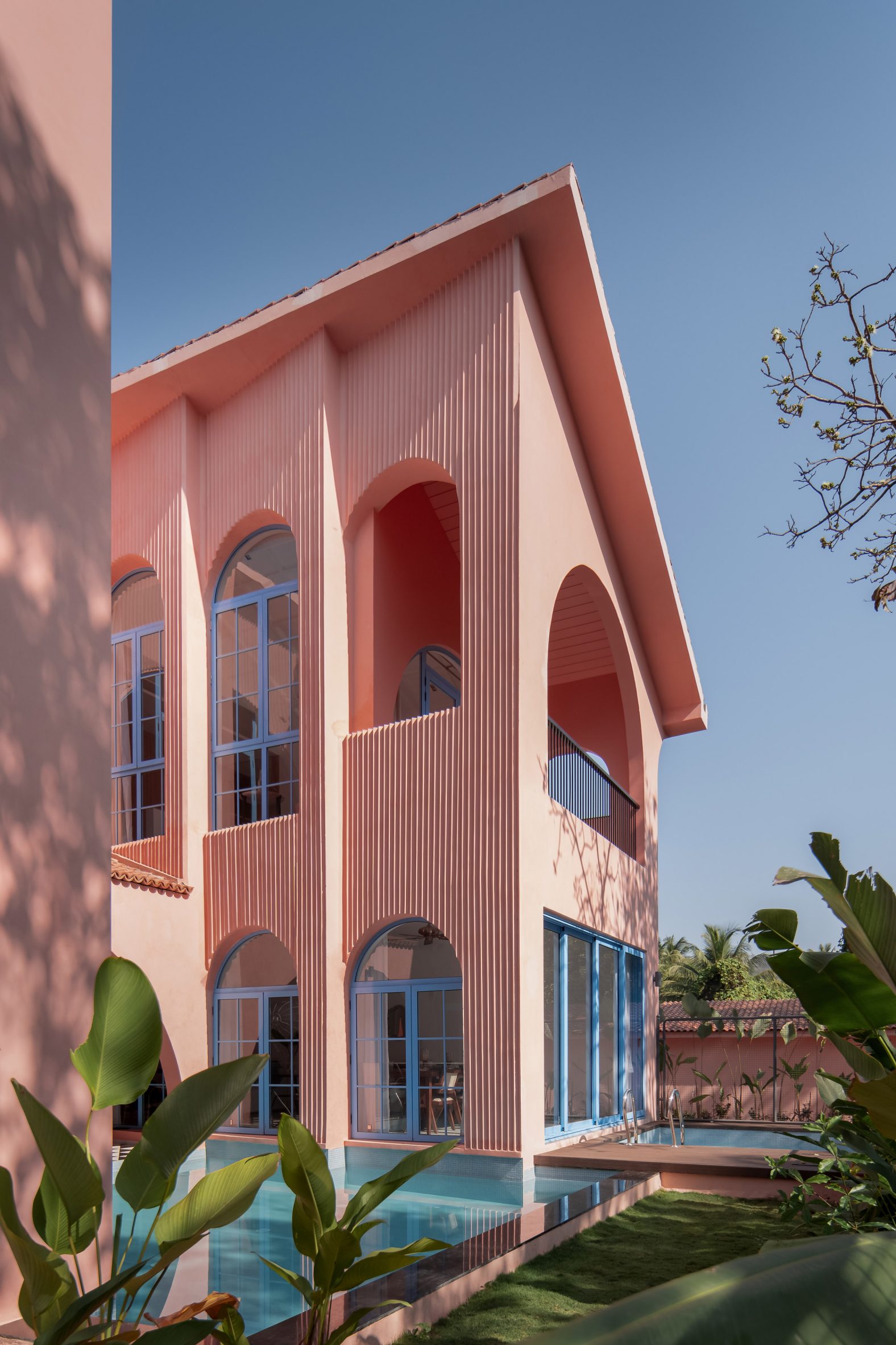 Pink holiday villas with swimming pools by Jugal Mistri Architects