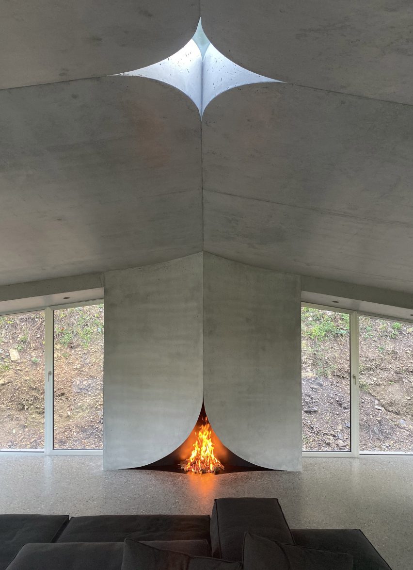 Interior of a concrete house with a fireplace