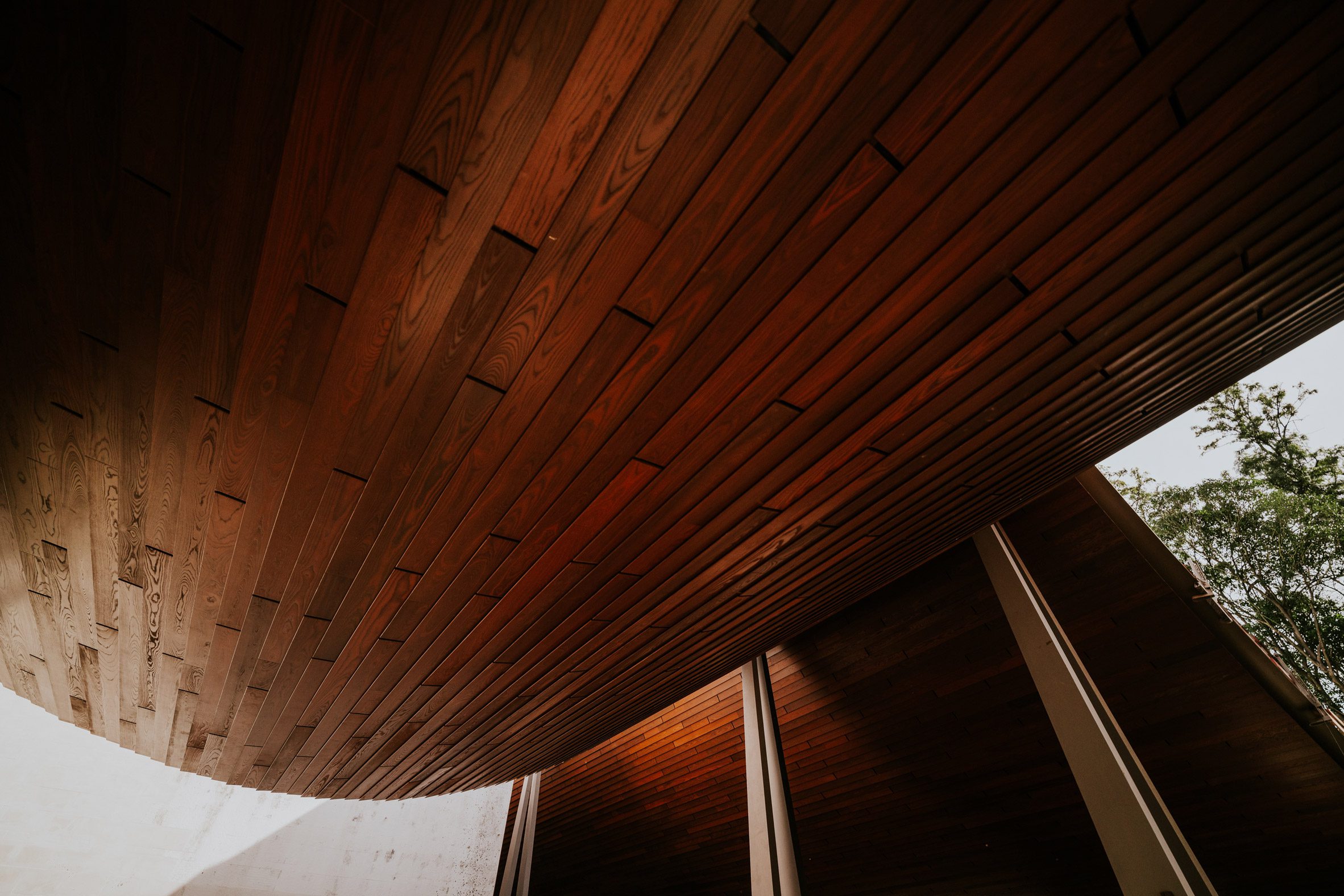 Wooden underside of swooping roof by Kengo Kuma