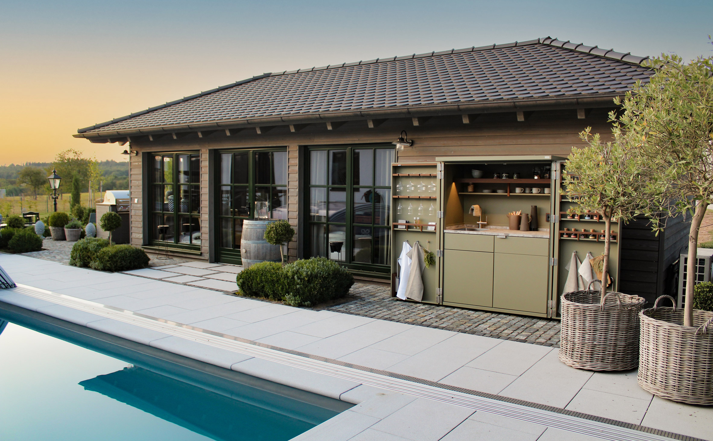 Outdoor kitchen alongside a swimming pool