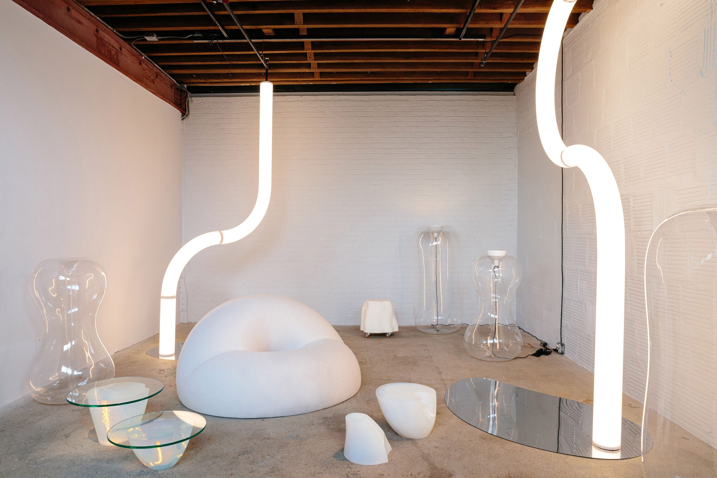 Room with white furniture and tubular lights