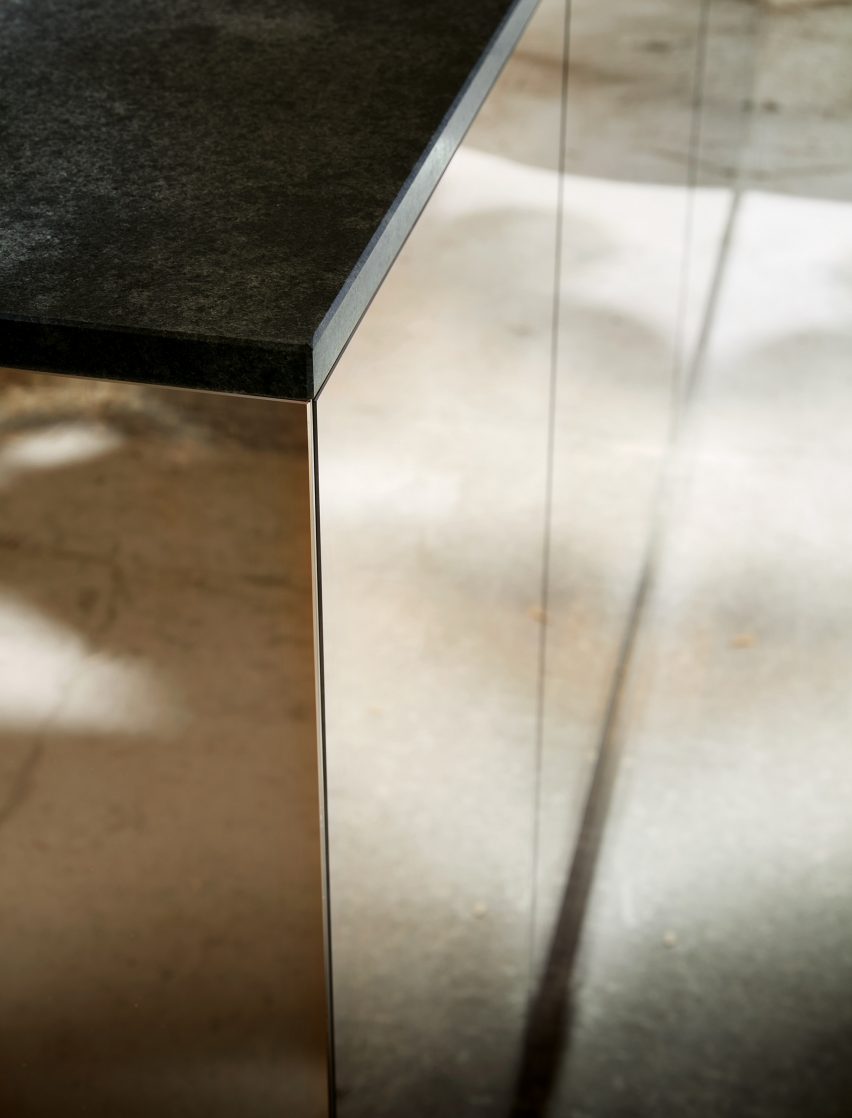 Mirrored surface of kitchen island within wooden pavilion by Francis Kéré