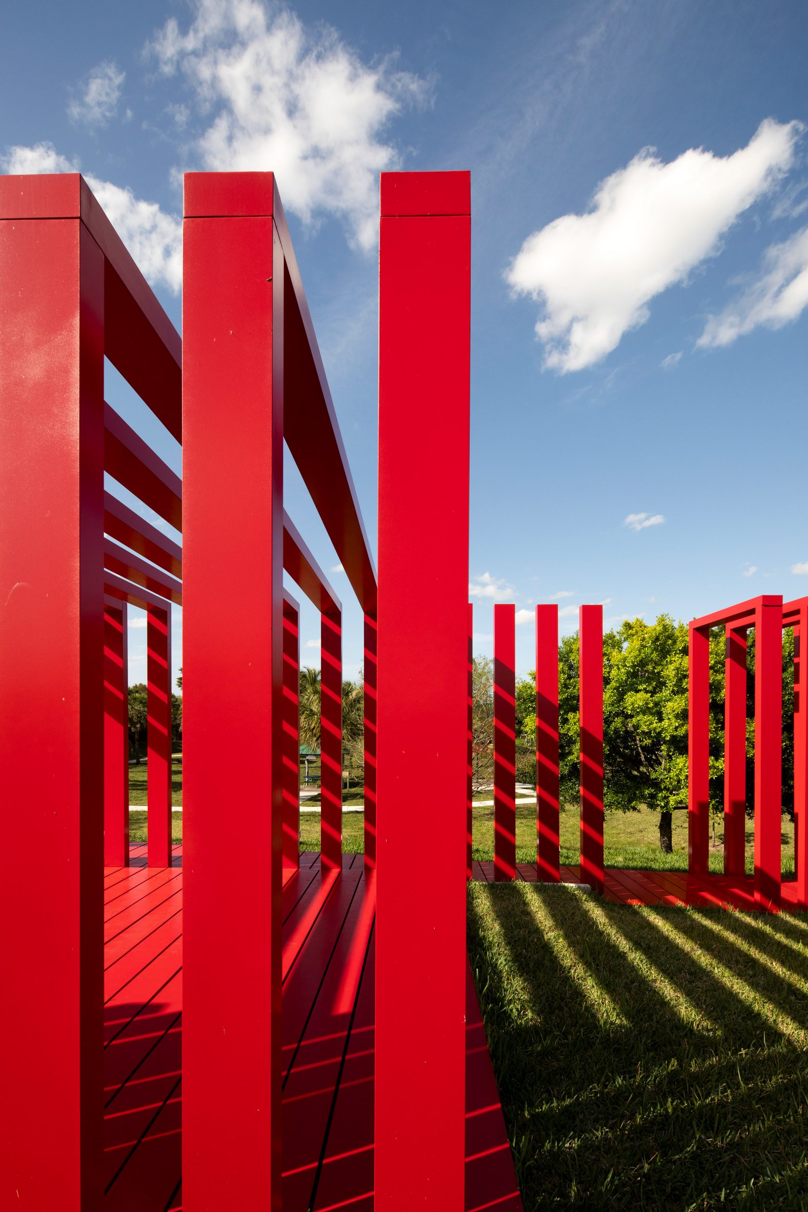 Red aluminium slats with shadows and clouds