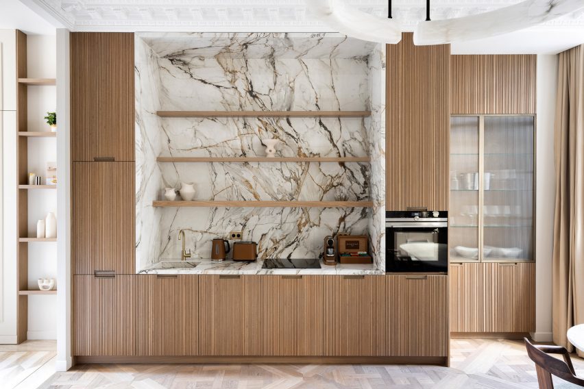 Kitchen with tambour-panelled cabinets and a marble backsplash