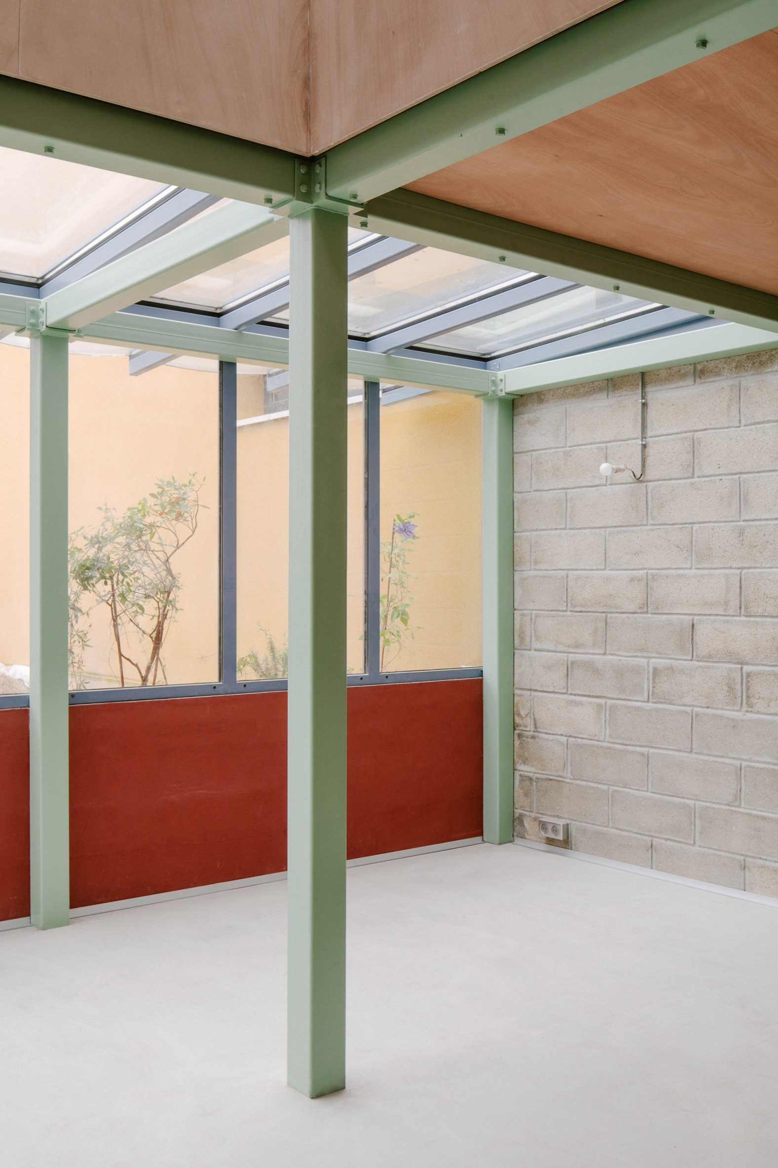 Garden room with blockwork walls and green steel structure