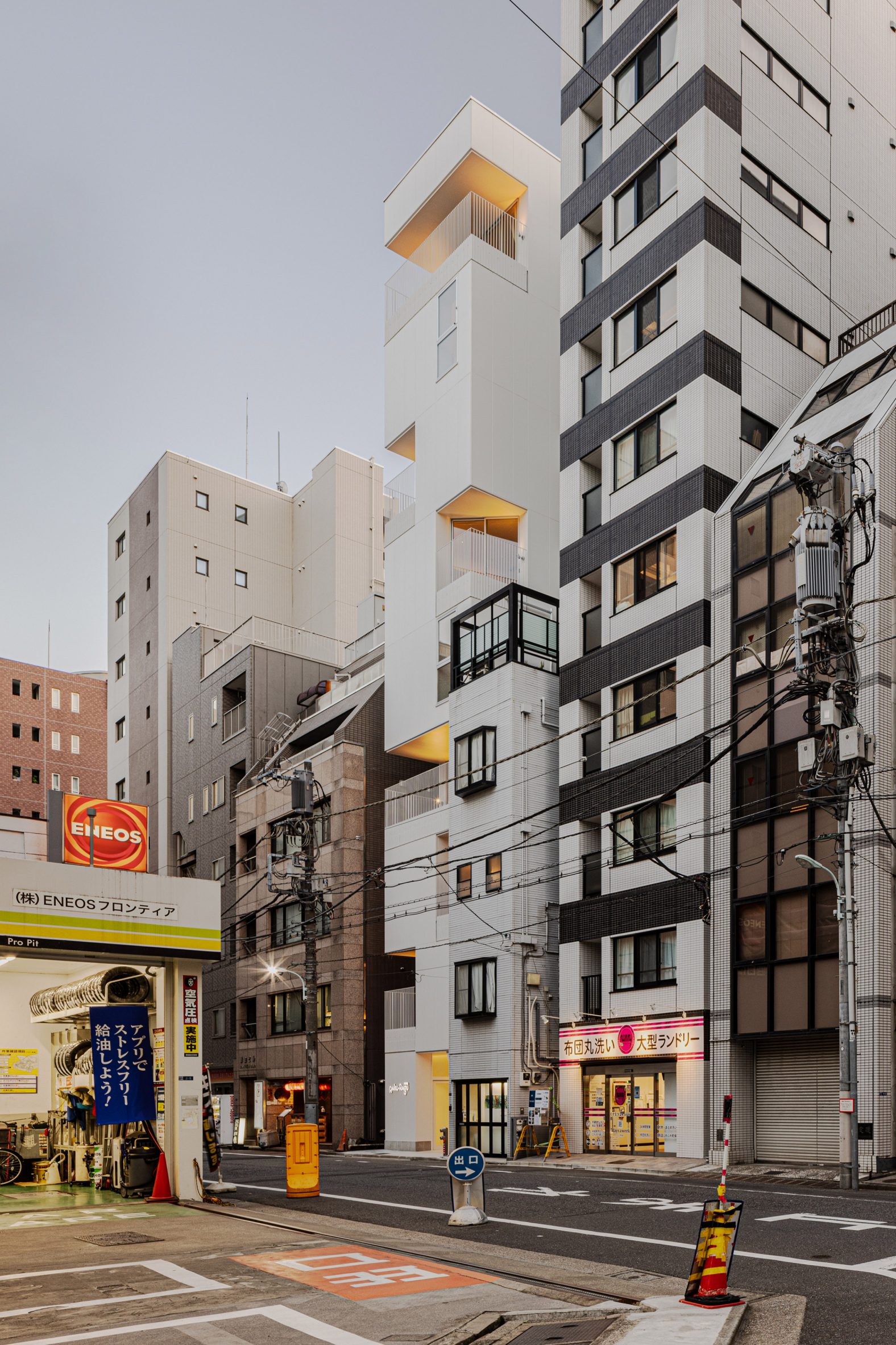 Narrow hotel in Tokyo with white facade