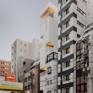 Kooo Architects creates narrow Tokyo hotel with cut-out balconies and terraces
