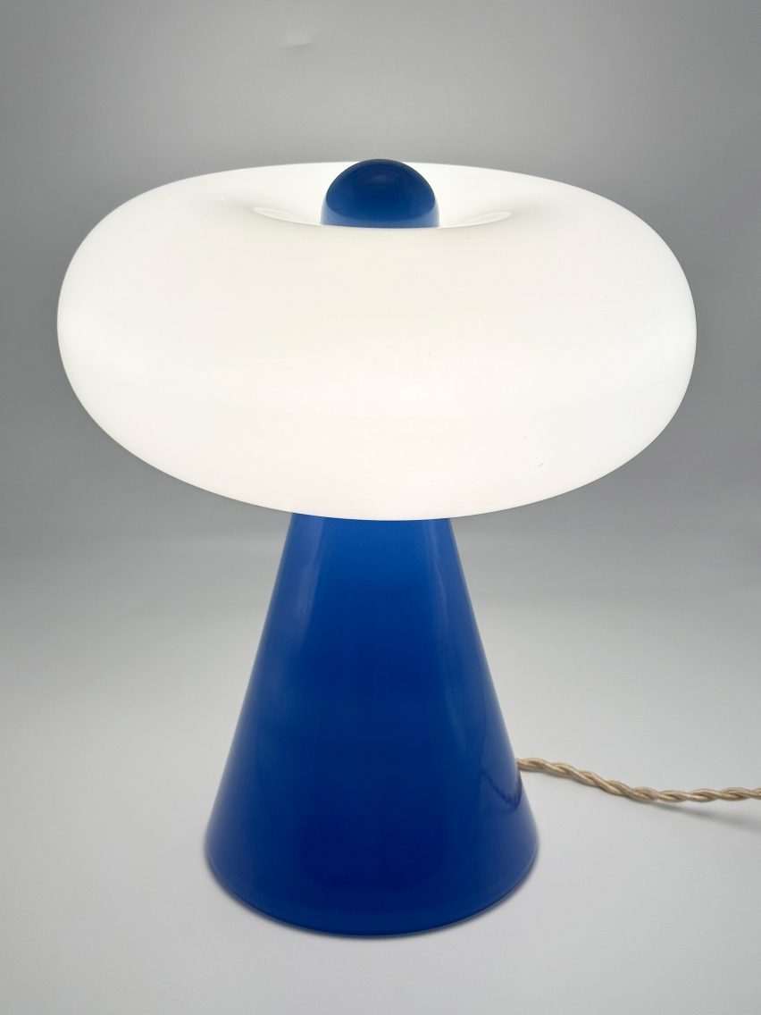 Blue conical light with doughnut-shaped bulb by Noiro Studio