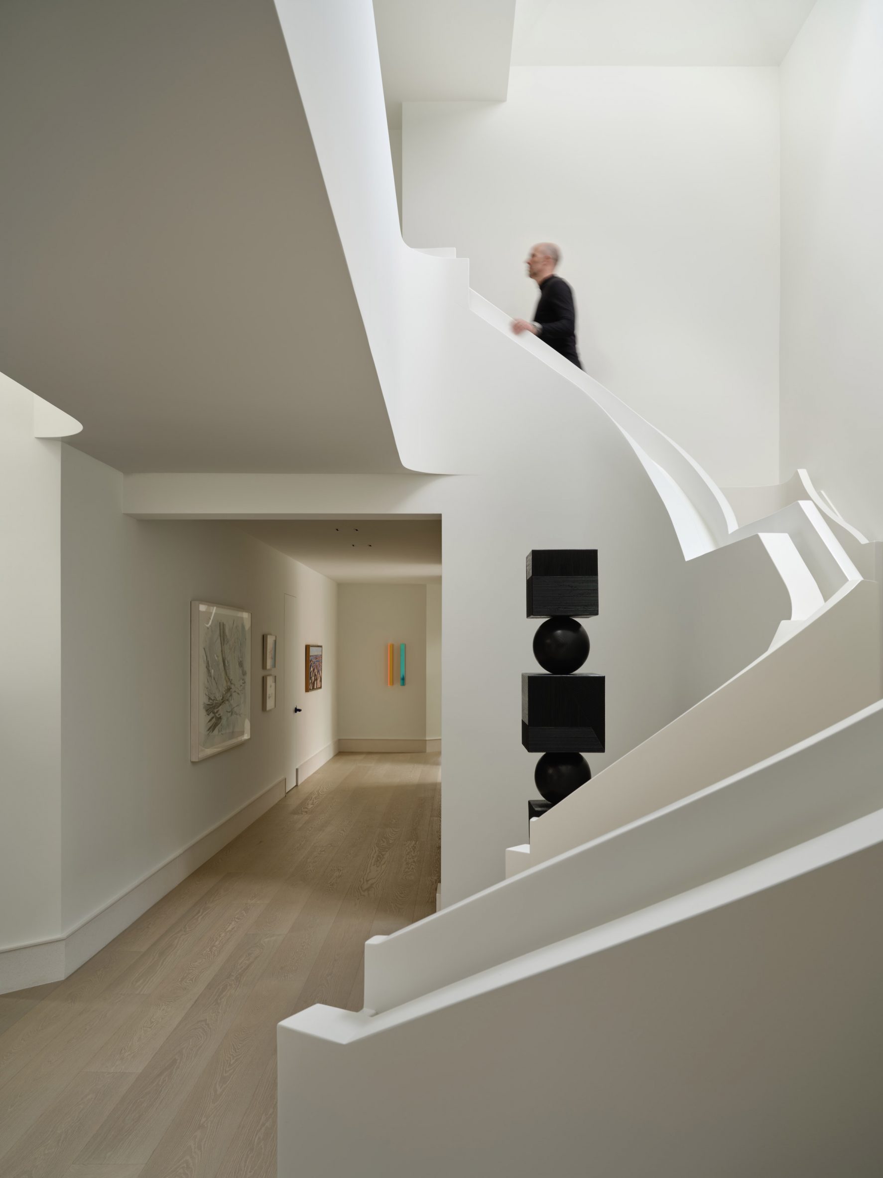 Sculptural white staircase with layered bannisters