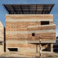 "Shifting shades" of rammed earth define Thai community building by Suphasidh Architects
