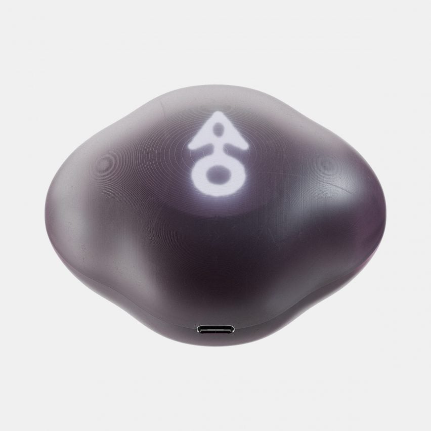 Product photo of the Terra device by Panter & Tourron and Modem Works Design, showing a smoothened rock-like object with a glowing arrow pointing forward
