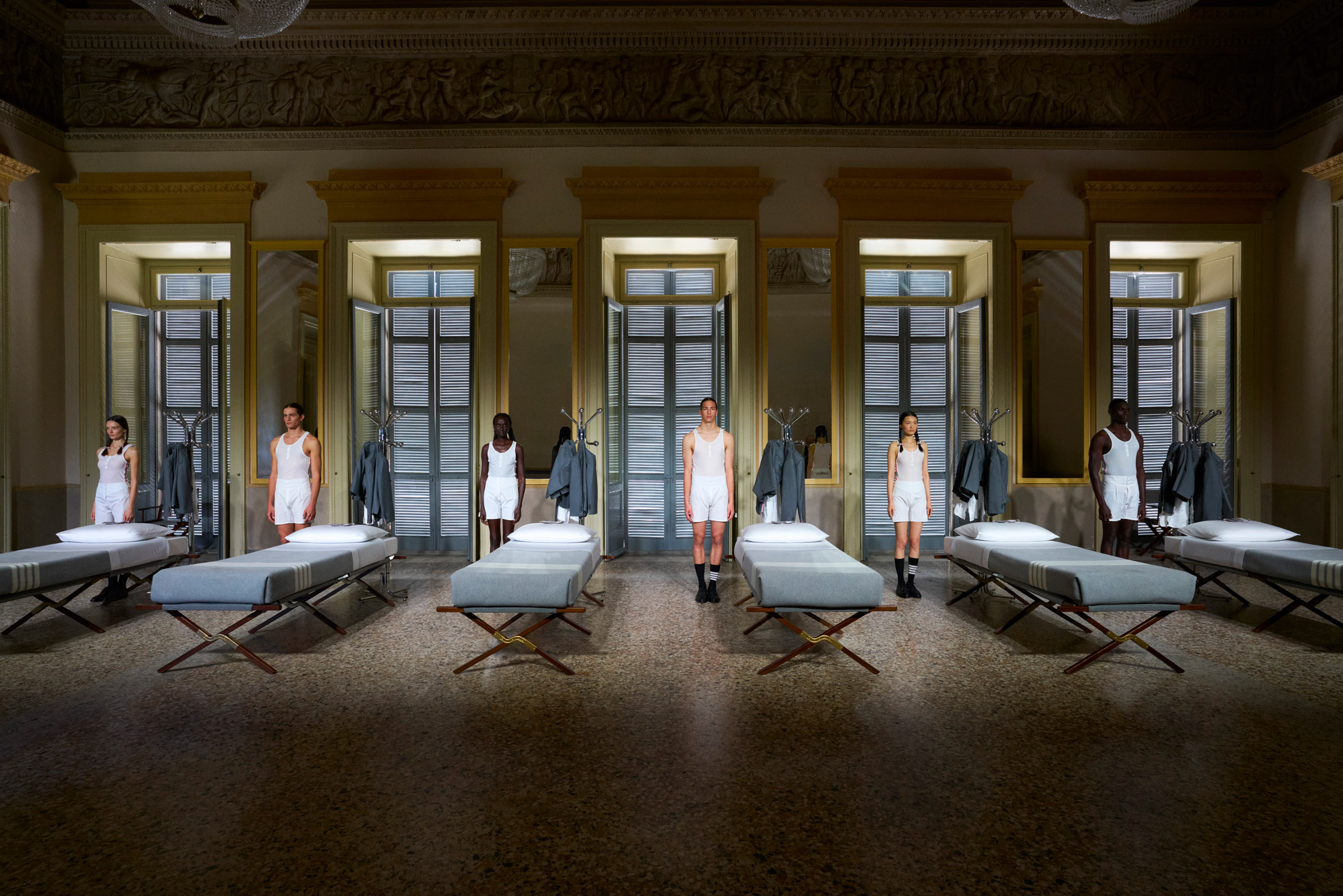 Six models wearing underwear stood beside their respective beds
