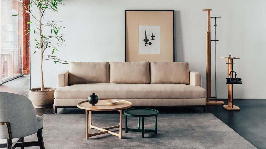 Photo of a room with a rug, sofa and side tables by Stellar Works