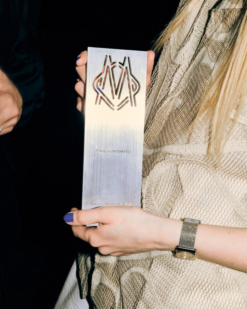 Award being held in a hand