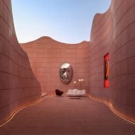 Ateno lines subway station in "continuous waves" of red concrete panels in China