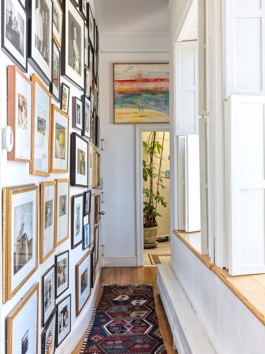 Corridor lined with paintings and photos