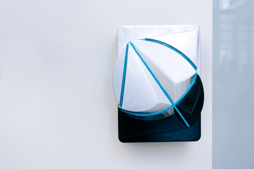 Wall-mounted charging point with blue geometric pattern on it