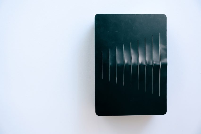 Black wall-mounted charging point with cut-out fins