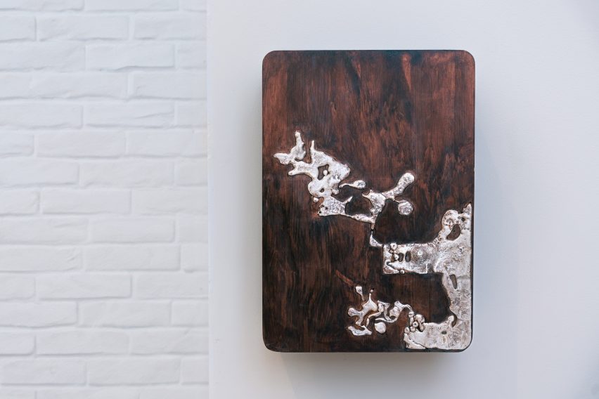 Wall-mounted charging point with wooden and metallic details