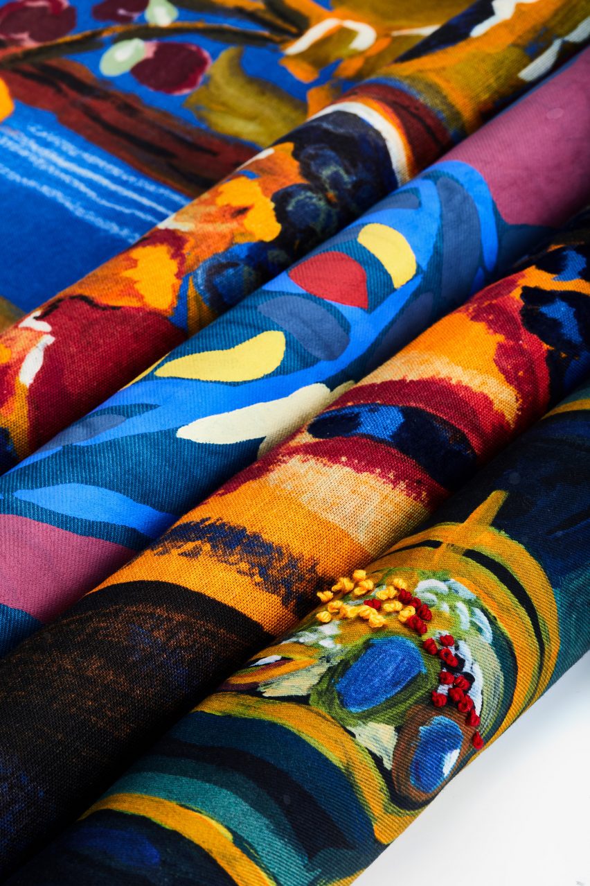 Four rolls of fabric in colours of blue, yellow, pink, red and orange.