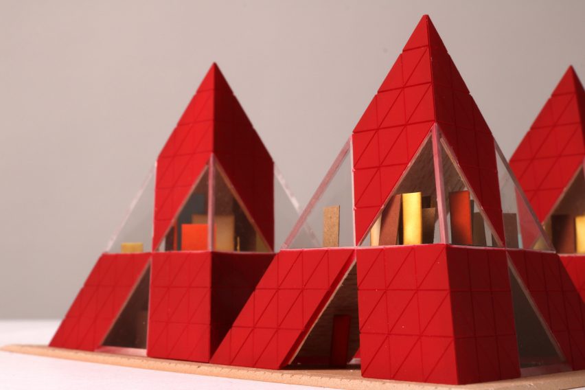 An architectural model with red triangular structures.