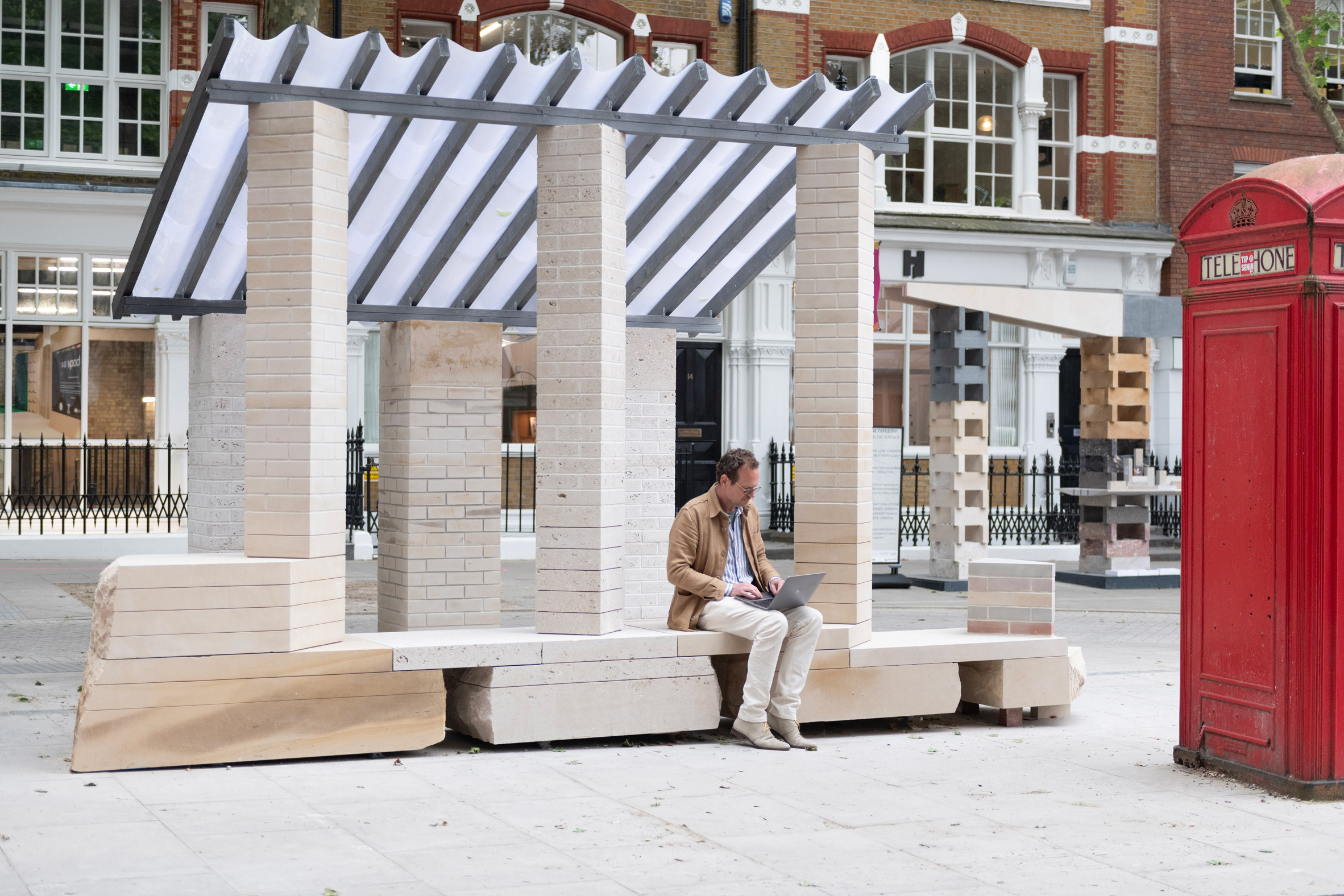 Man sitting on Brick from a Stone installation at Clerkenwell Design Week by Artefact for Hutton Stone and Albion Stone