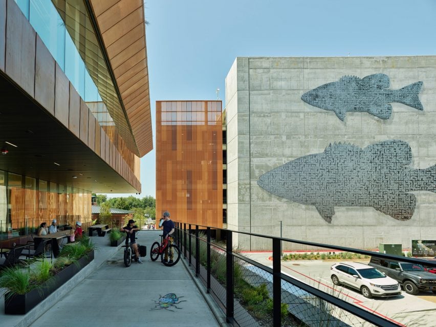 Kinetic fish on the facade of the concrete parking garage