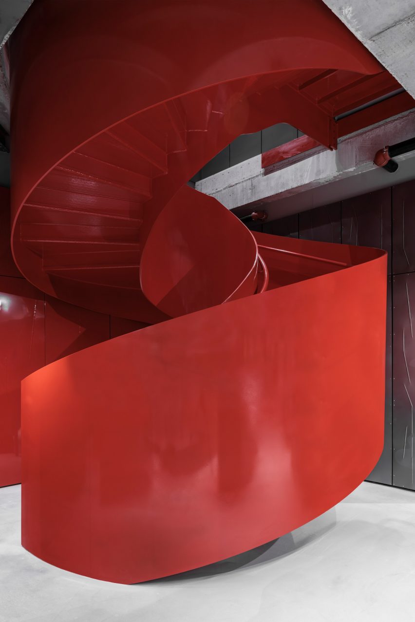 A red lacquered-metal spiral staircase