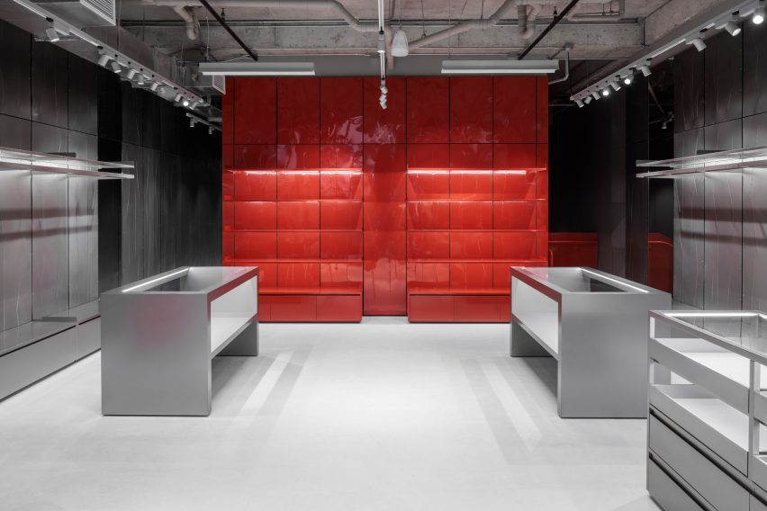 Red display wall that stands out against the concrete and metallic surfaces