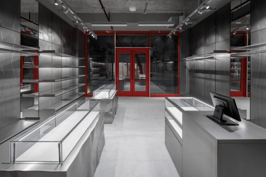 Store interior featuring vitrines atop crinkled metal bases