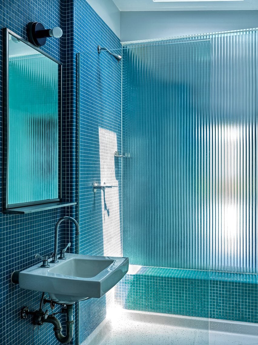 Blue-tiled bathroom with fritted glass
