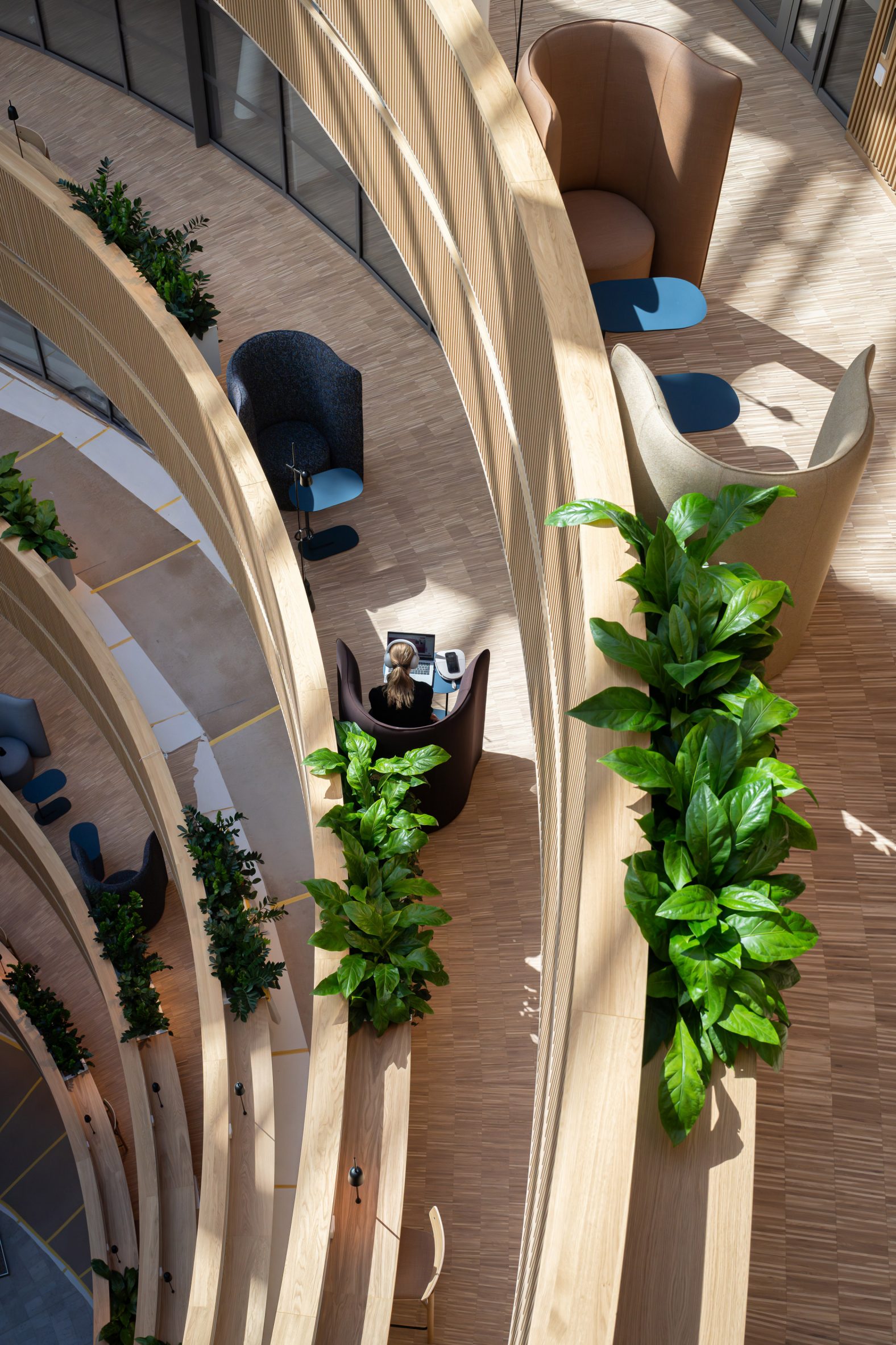 Seating spaces within the atrium at hub by 3XN