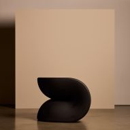 Black chair against a cream backdrop