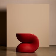 Red chairs against a cream backdrop