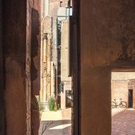 View looking past wall into a courtyard