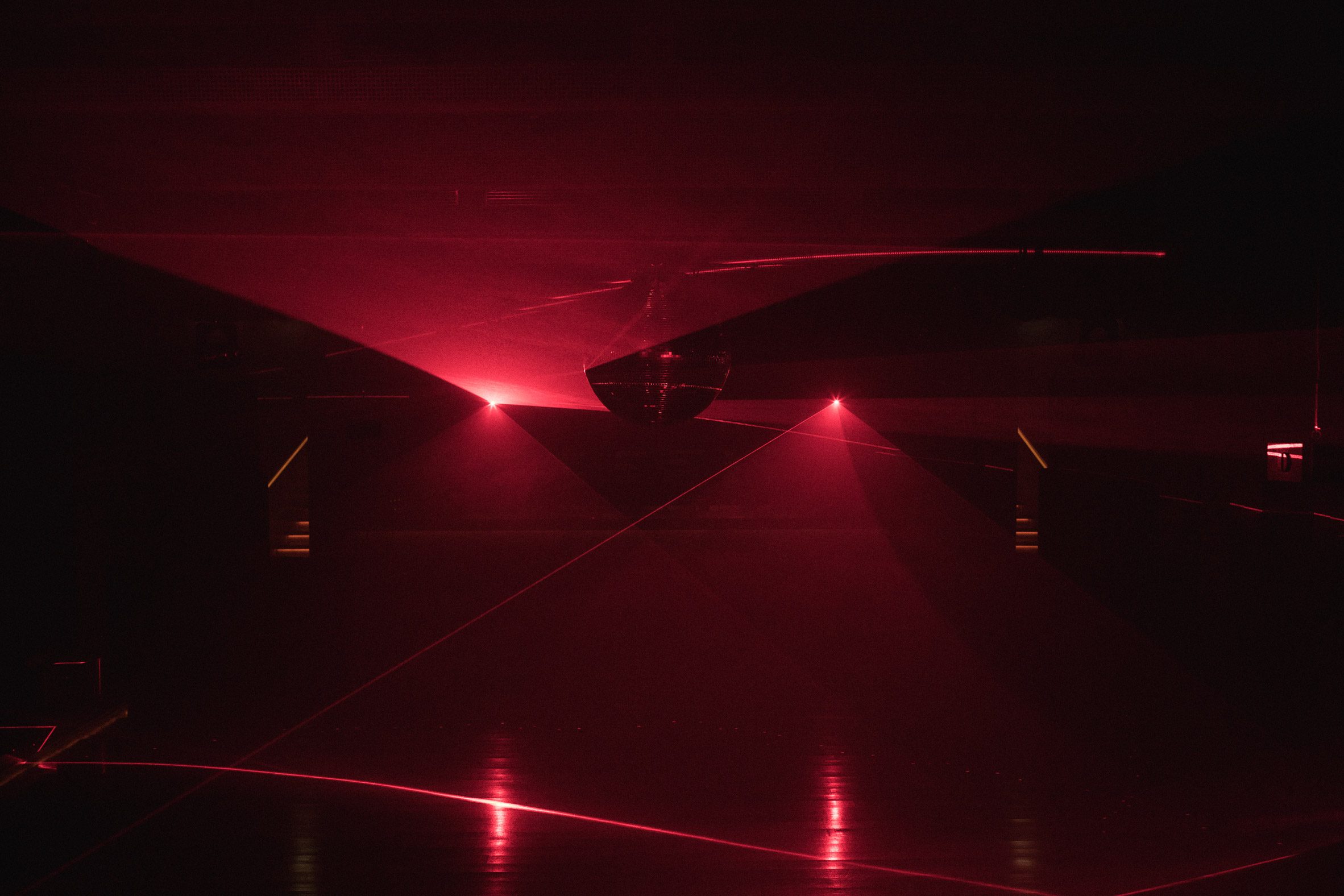 Dark nightclub with red laser lighting