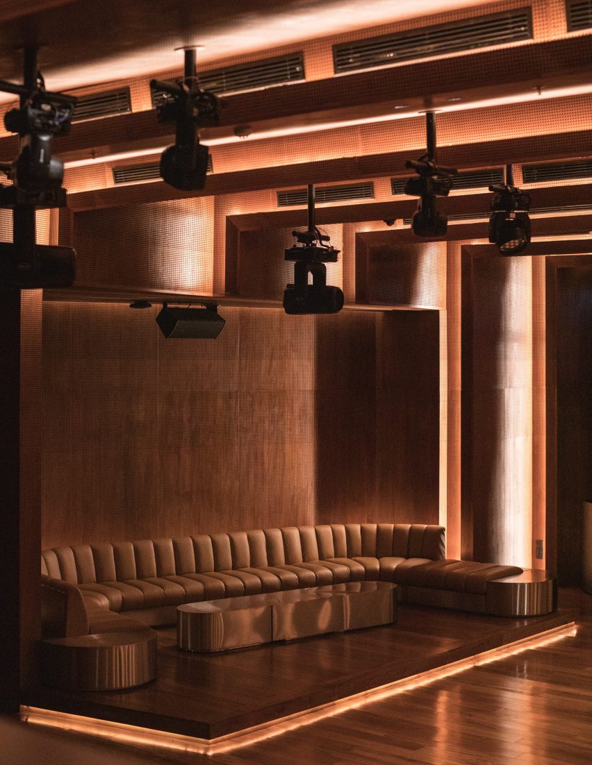 Teak-panelled nightclub with a seating area of built-in leather chairs