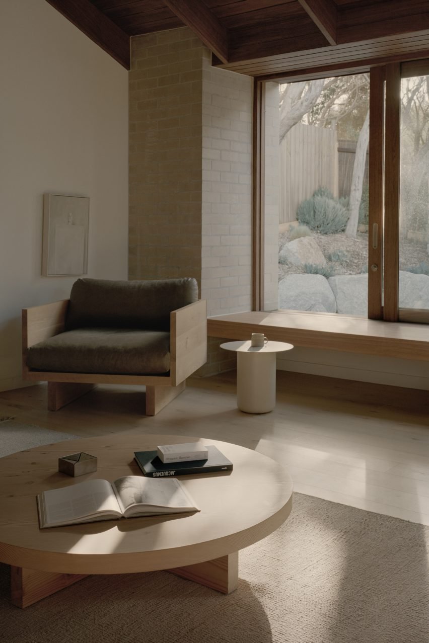 White-walled living room with exposed wood and brick details