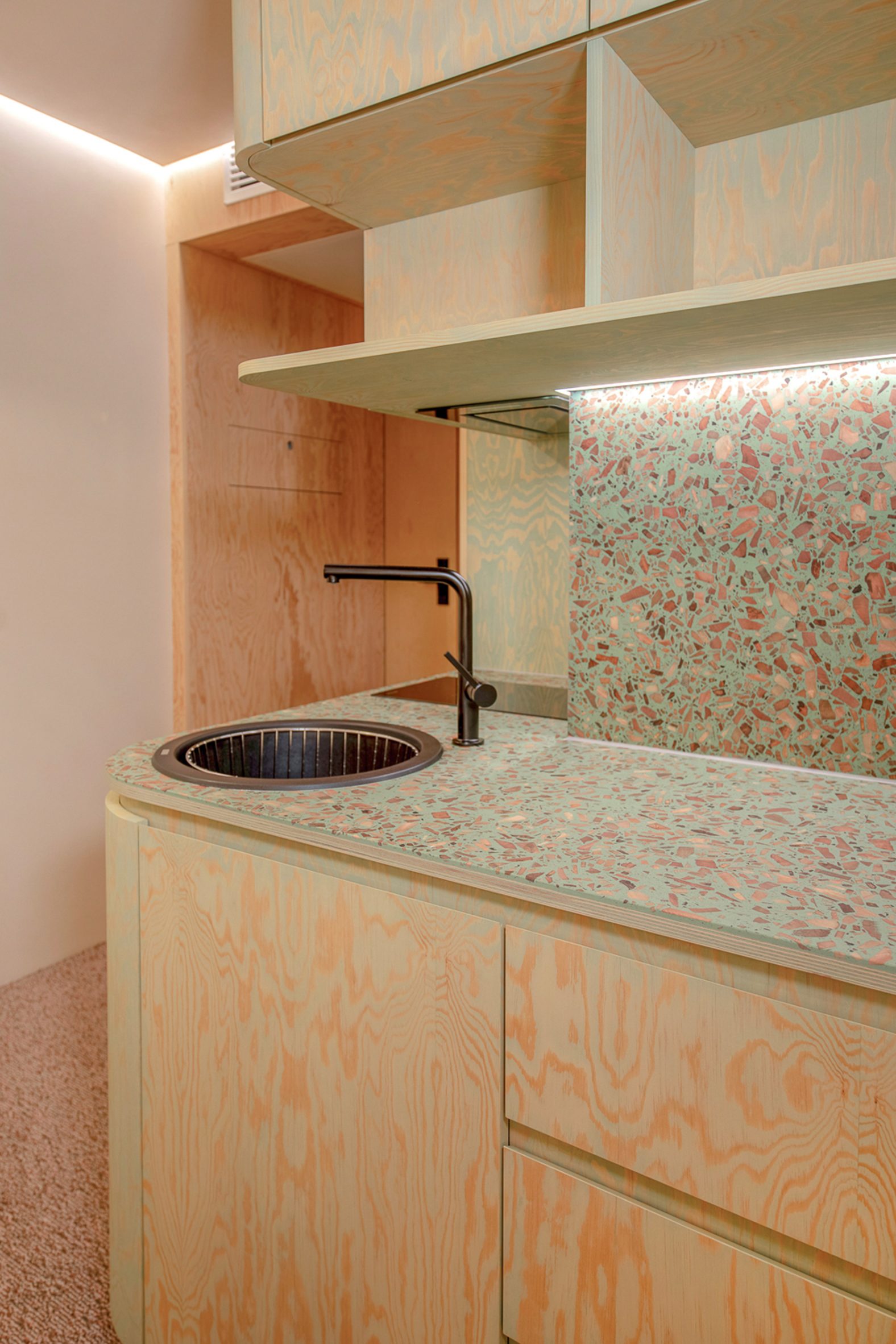 Green kitchen with terrazzo counter
