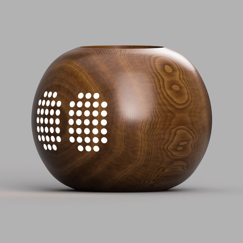Visualisation of a brown wooden electronic home assistant with multiple small white lights.