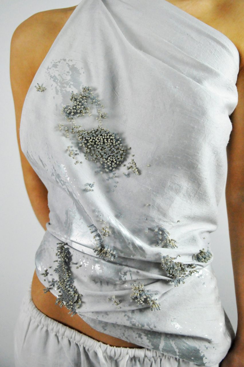Model wearing grey garments encrusted with beads