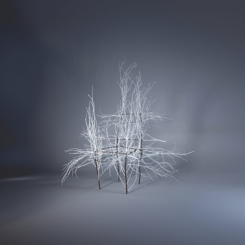 Chair frame with white branch-like structure attached to it
