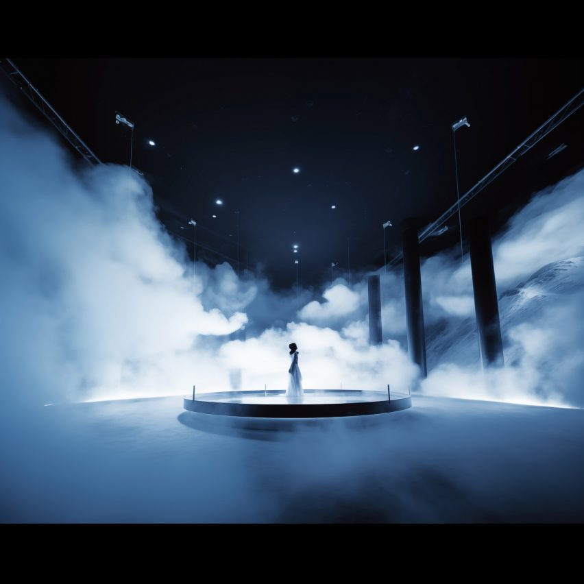 Visualisation of a person on a stage in a white dress, with blue and white smoke around them.