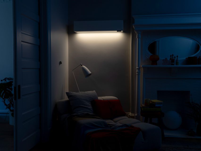 Photo of the accent light on the wall-mounted Quilt indoor home climate unit lighting up a reading corner in a dark room