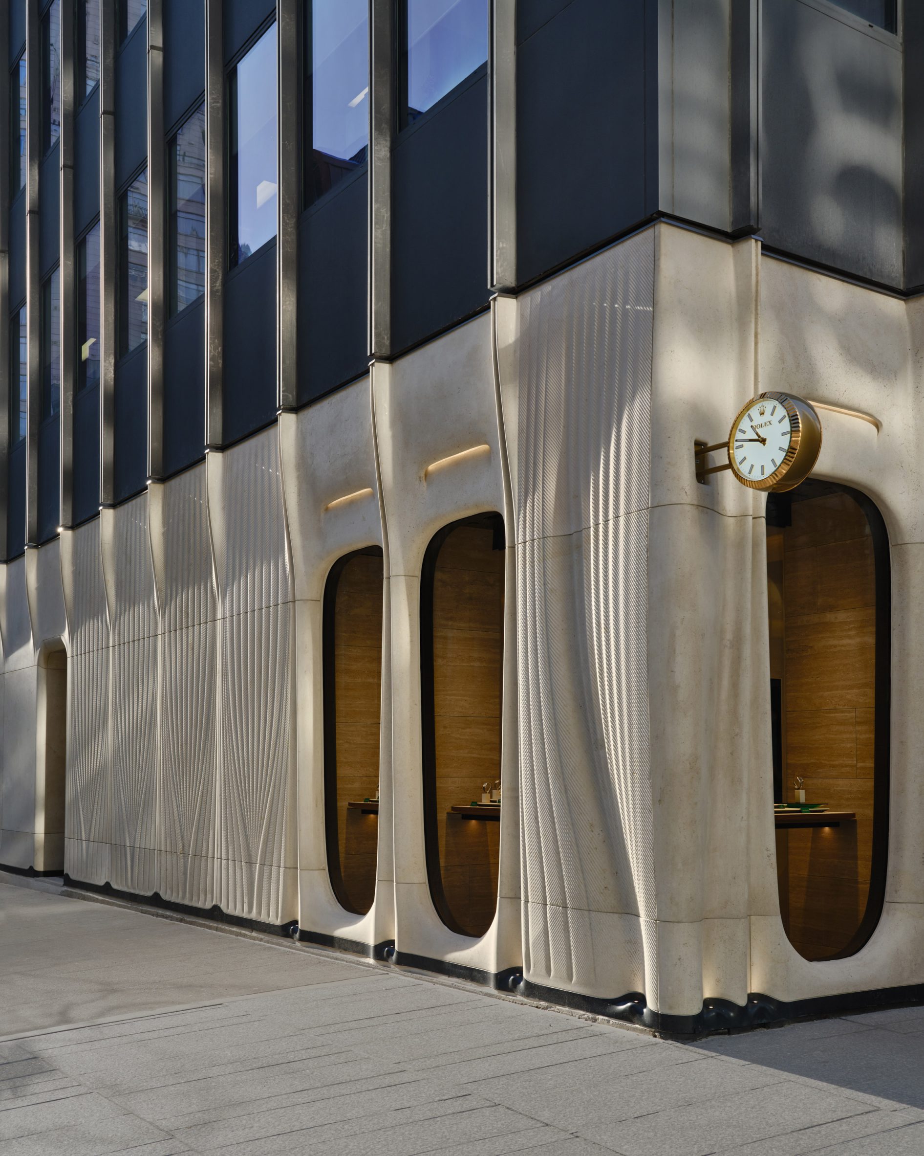 Corner of limestone facade surrounding Rolex boutique in Toronto