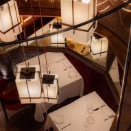 Lanterns dangle through hole between floors in "UK's most expensive steak" restaurant