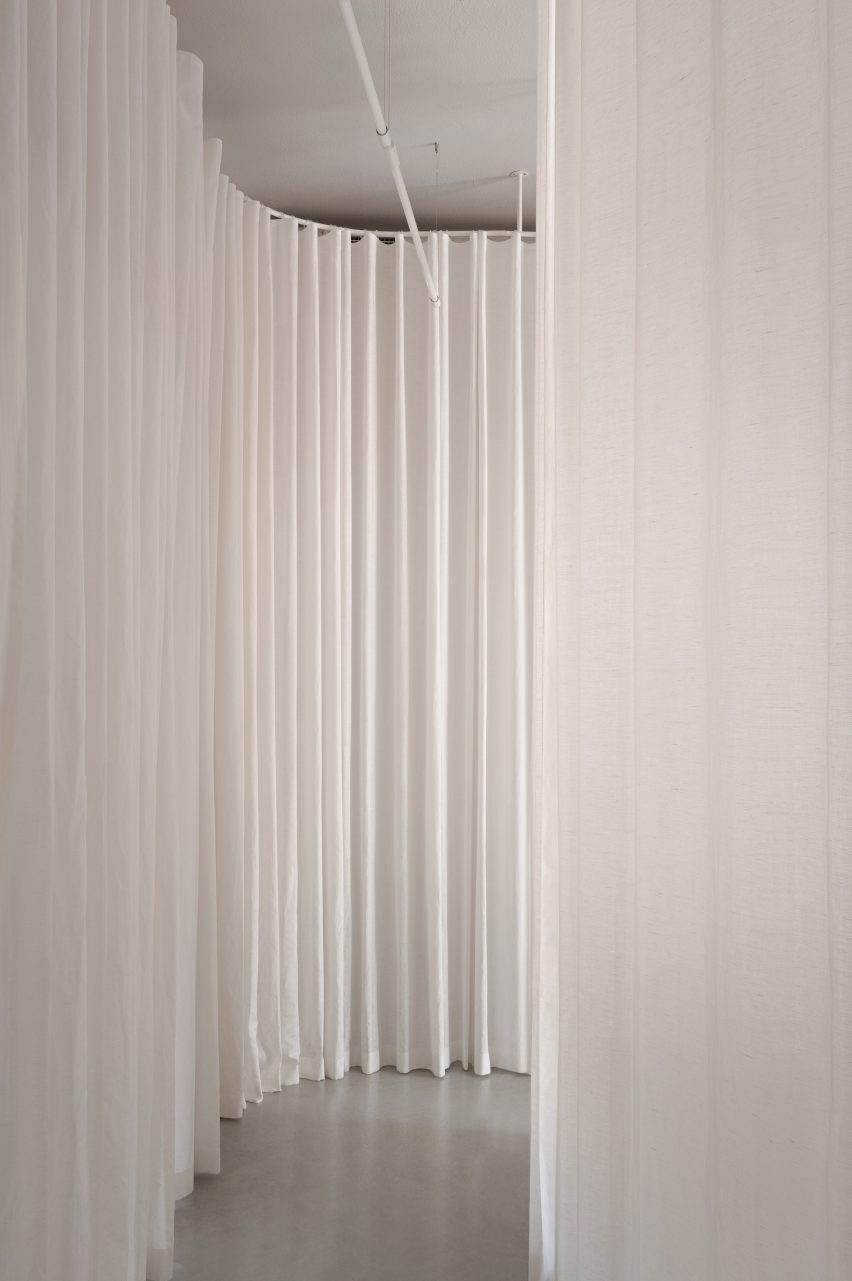 A white curtain curved in the corner
