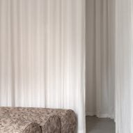 White curtain with curving sofa